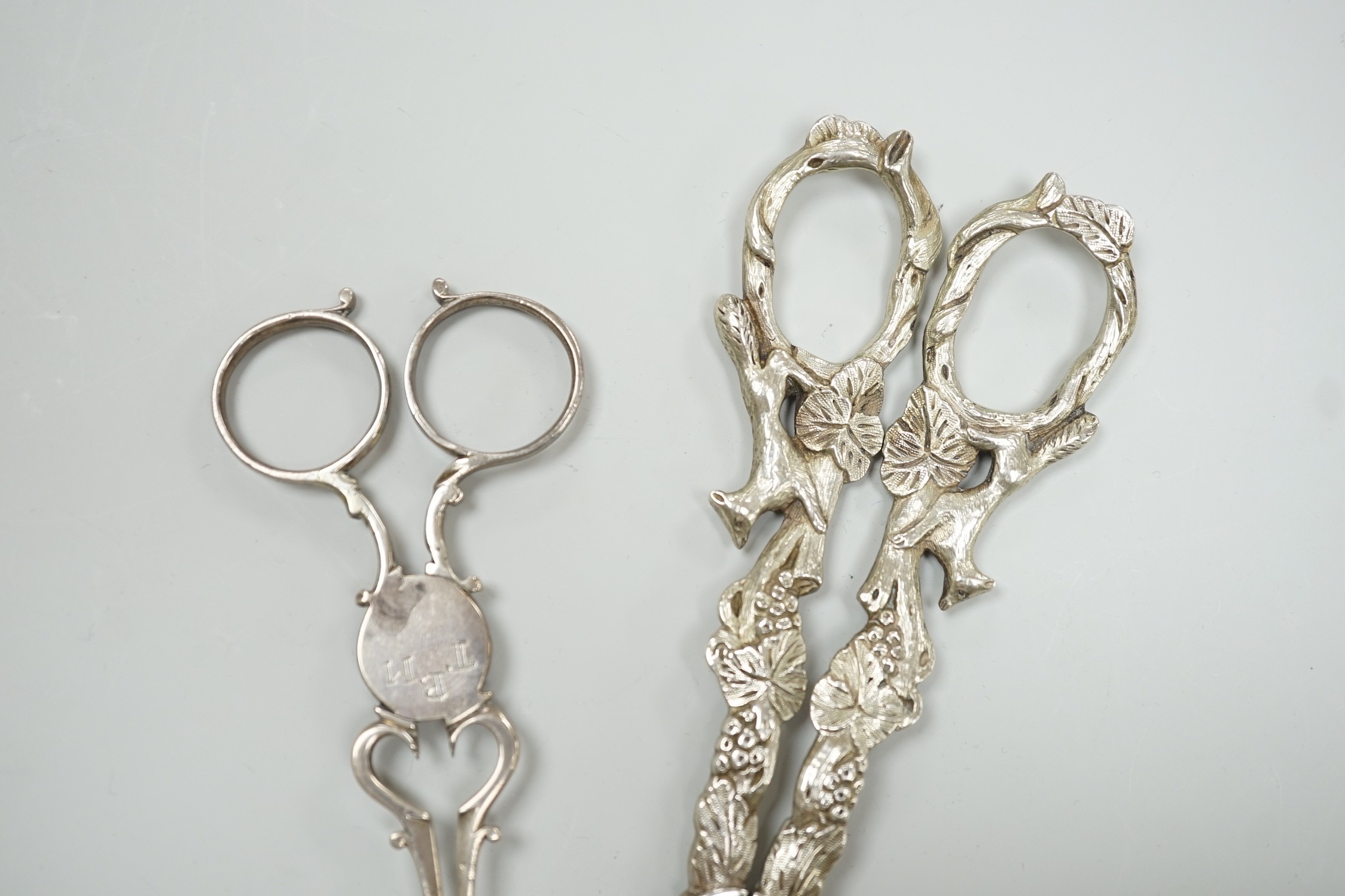 A pair of Victorian silver grape scissors, TS?, London, 1879, 17cm and a pair of Georgian silver sugar nips by Simeone Coley?